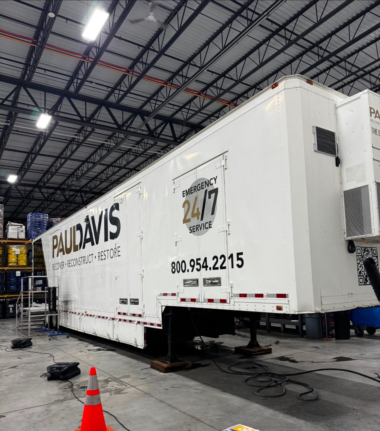 Geo-Trac-equipped restoration trailer and drying equipment staged in a warehouse